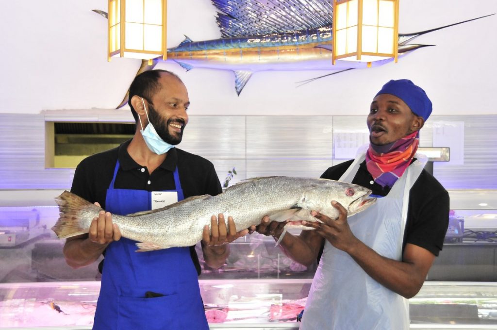 Sunninghill square | Johannesburg, Sandton, Mall, Shopping Centre, Convenient, Near Me, South African, Local, Affordable, Quality,2 chefs holding a fish ,white kitchen walls , sword fish hanging on the wall Iceland Seafood